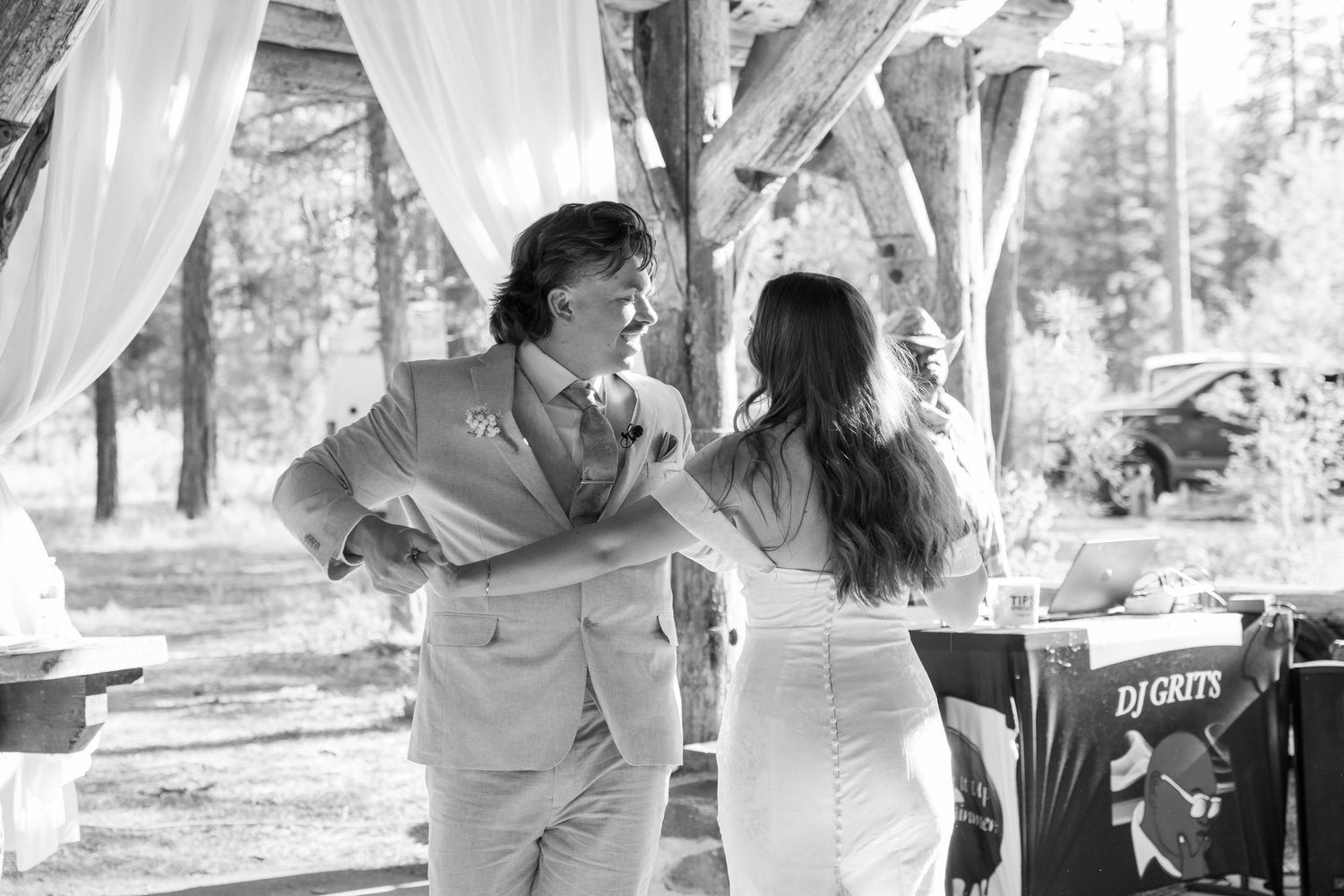 A romantic dance sequence unfolds beneath a wooden pavilion with white drapes and forest views.