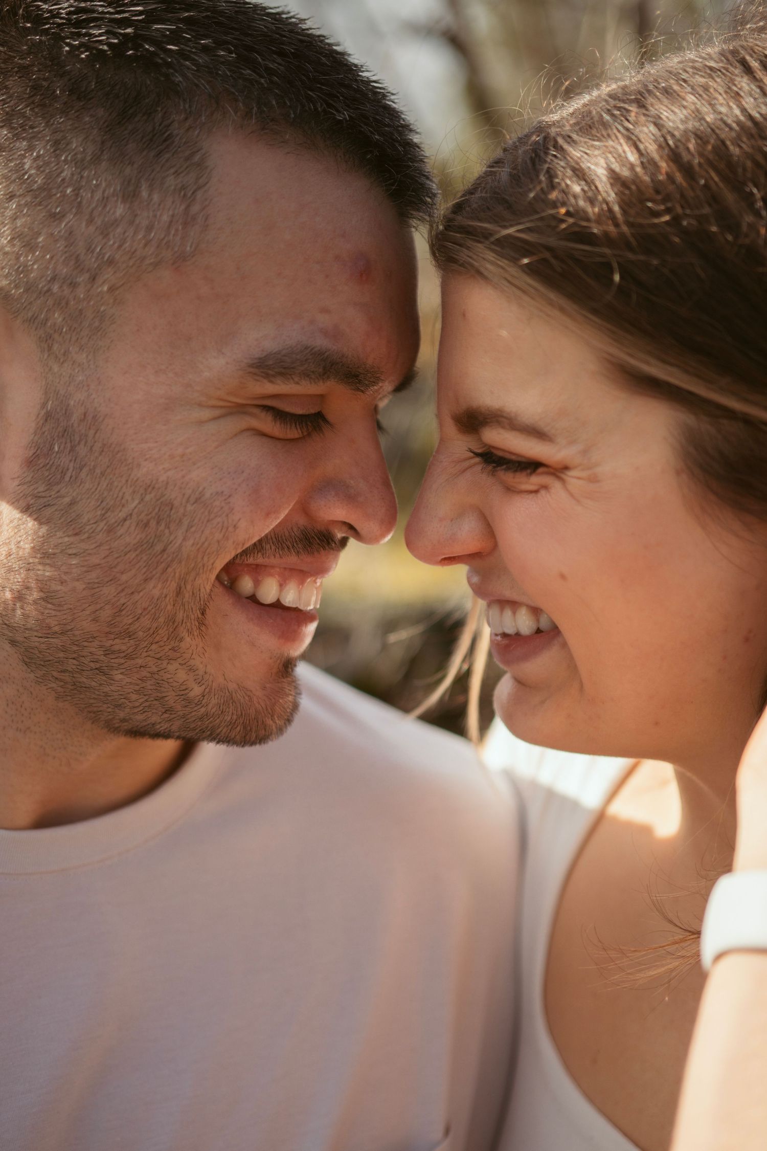 Romantic close-up shots of a couple sharing intimate moments in warm sunlight.