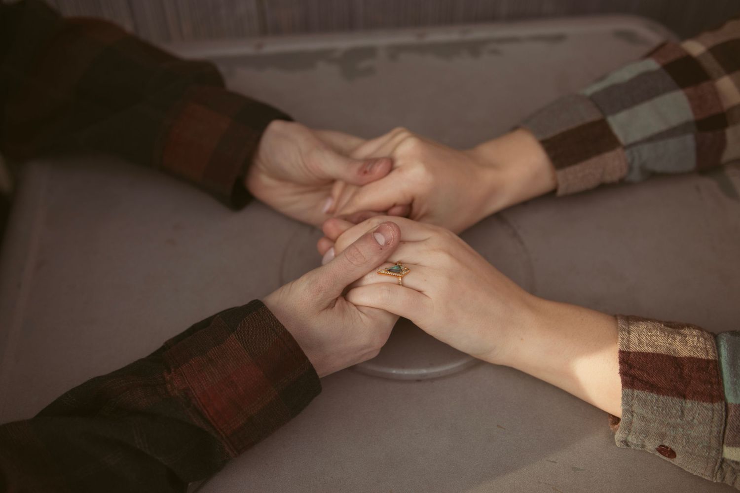 Close-up of hands touching and intertwining in an intimate moment.