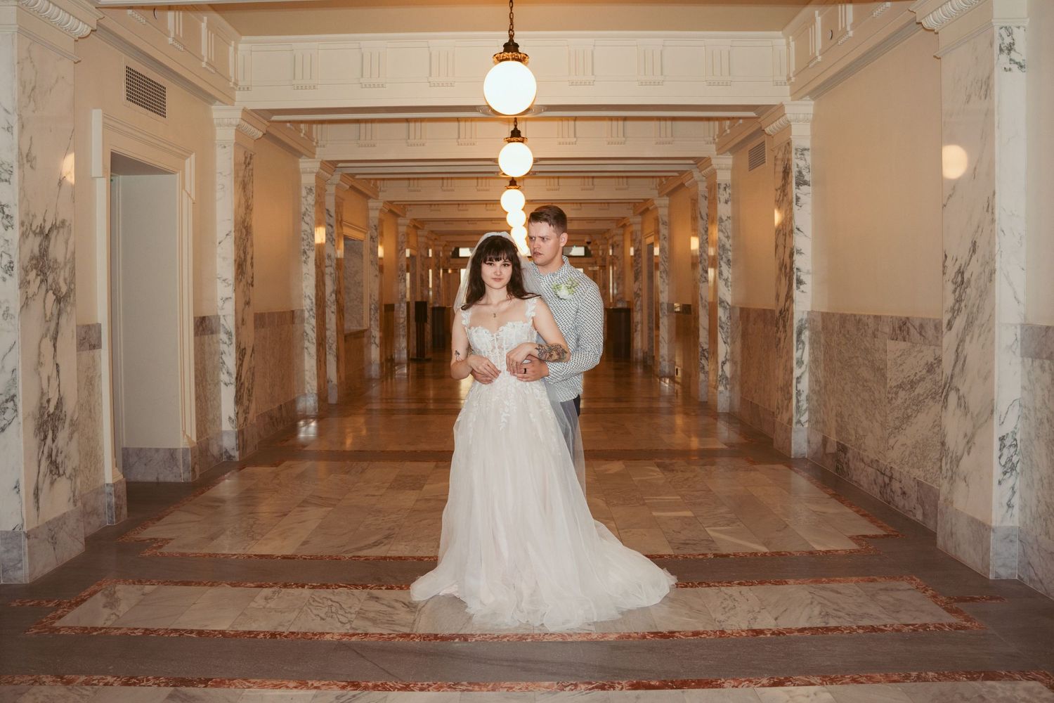 Elegant marble hallway with columns and ornate architectural details.