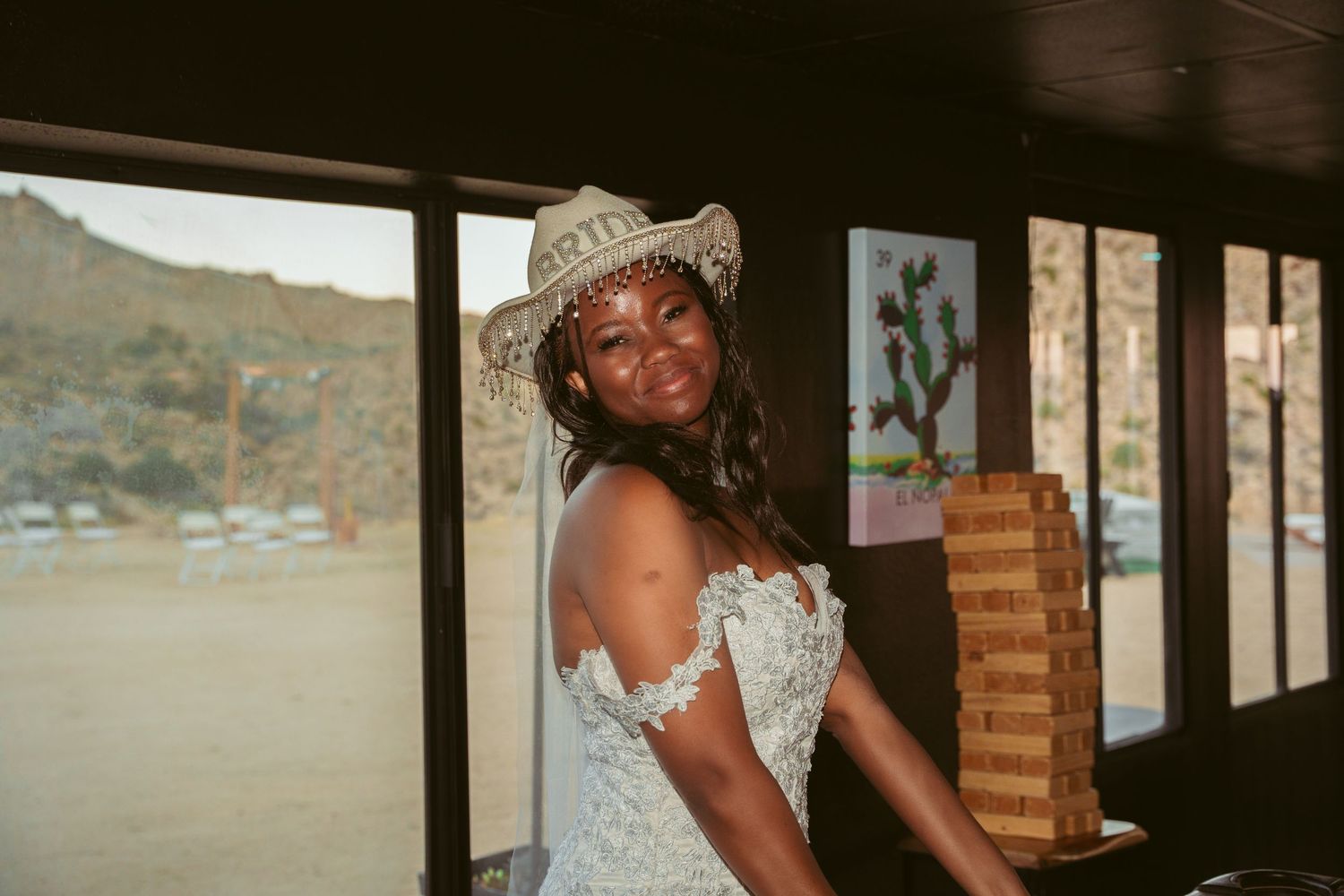 Wedding celebration in a rustic venue with large windows.