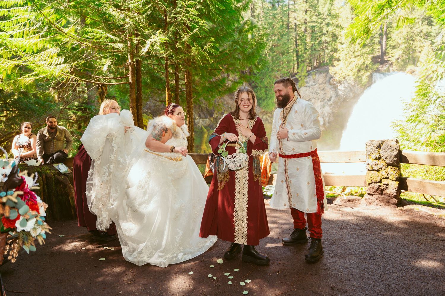 Medieval-themed wedding ceremony taking place on a forest path with decorative elements.
