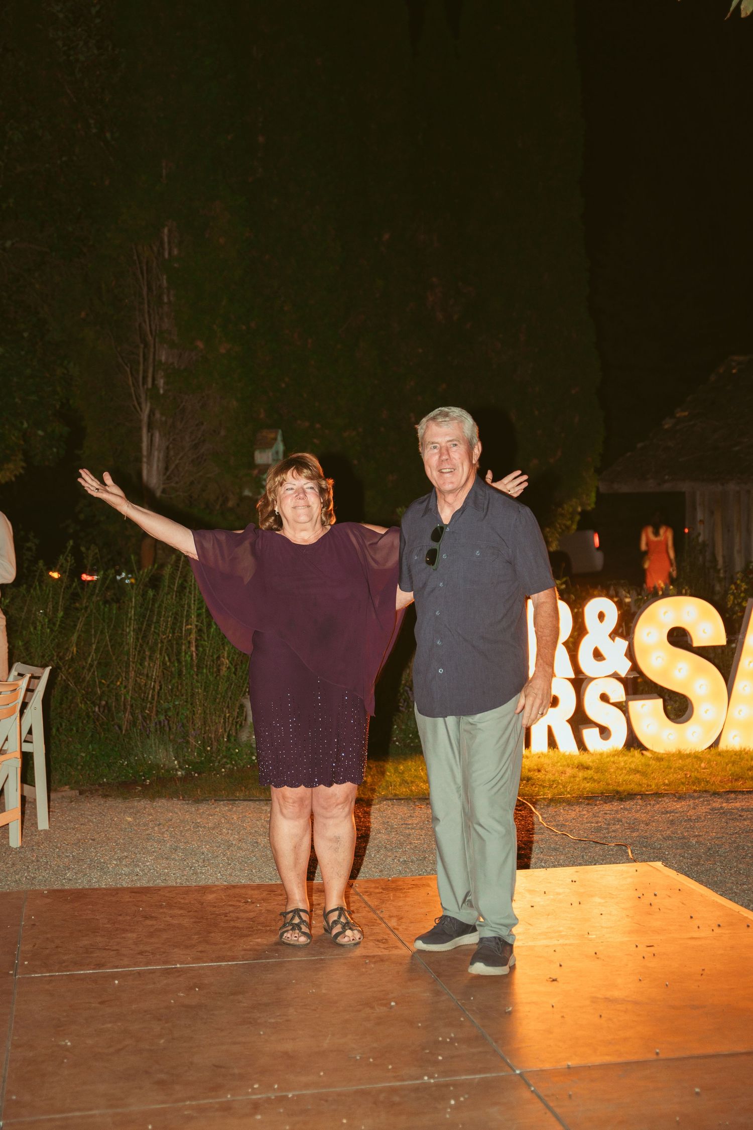 Illuminated letters spell out text against a dark outdoor backdrop at night.