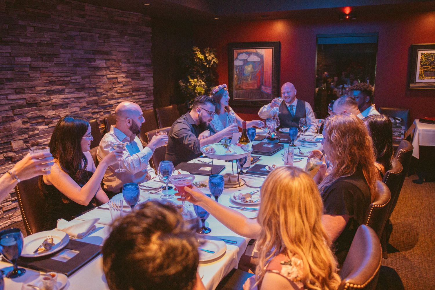 Dimly lit restaurant interior with guests seated at tables for a special evening event.
