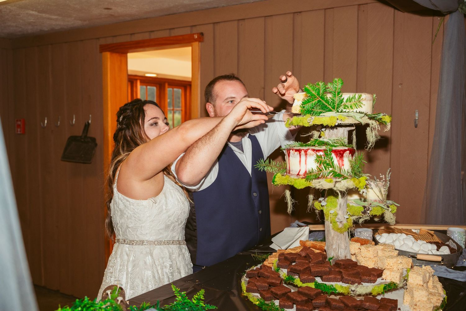 Newlyweds engage in traditional cake feeding moment at their reception.