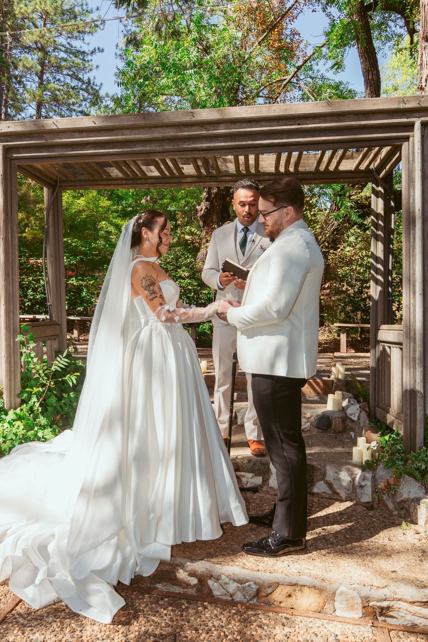 Series of candid wedding moments captured under a wooden pergola in a natural outdoor setting.