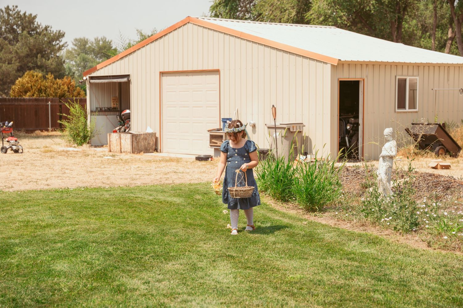 A panoramic view of a rustic ranch property with beige buildings and green landscaping.