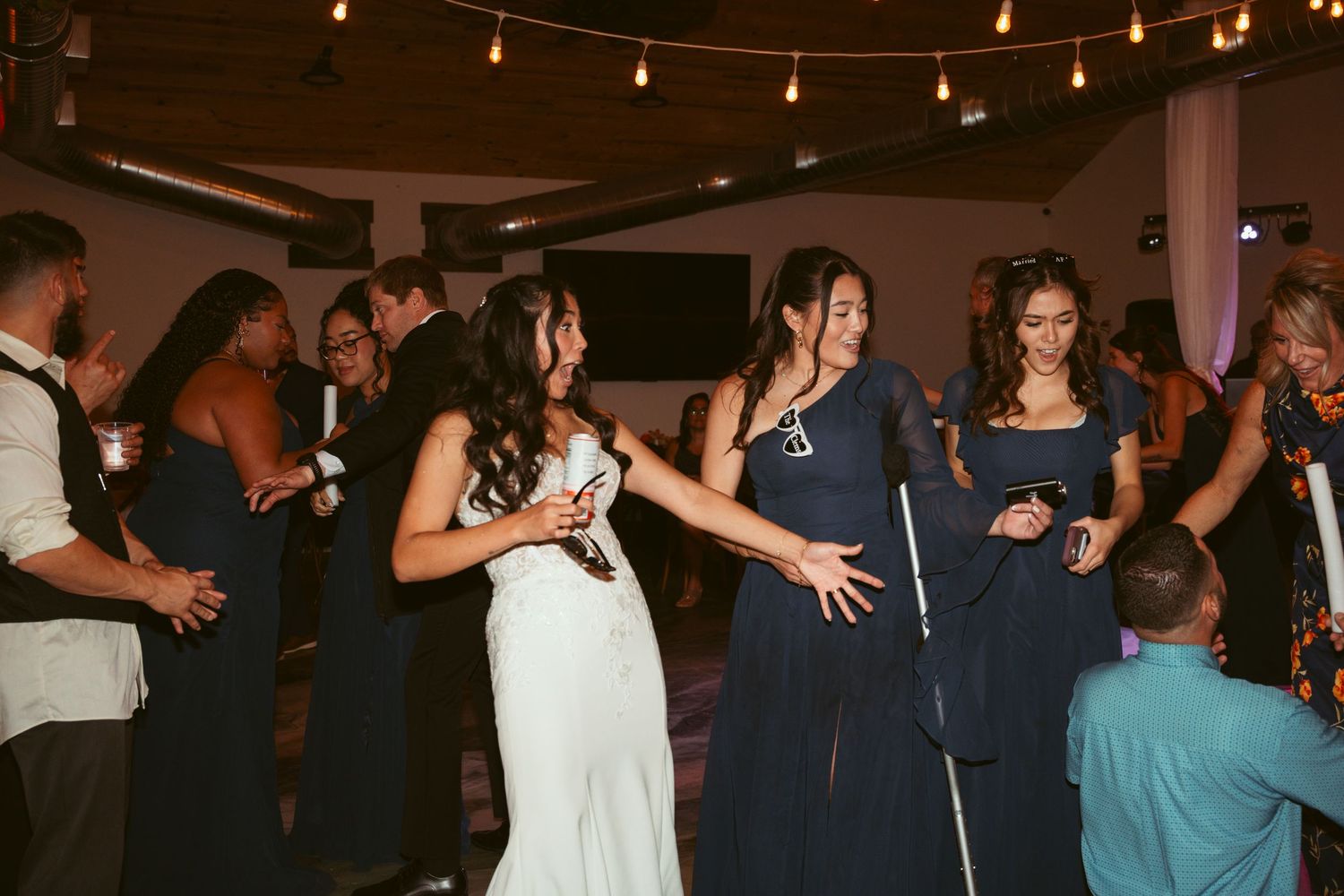 Evening celebration with dancers moving to music under decorative indoor lighting.