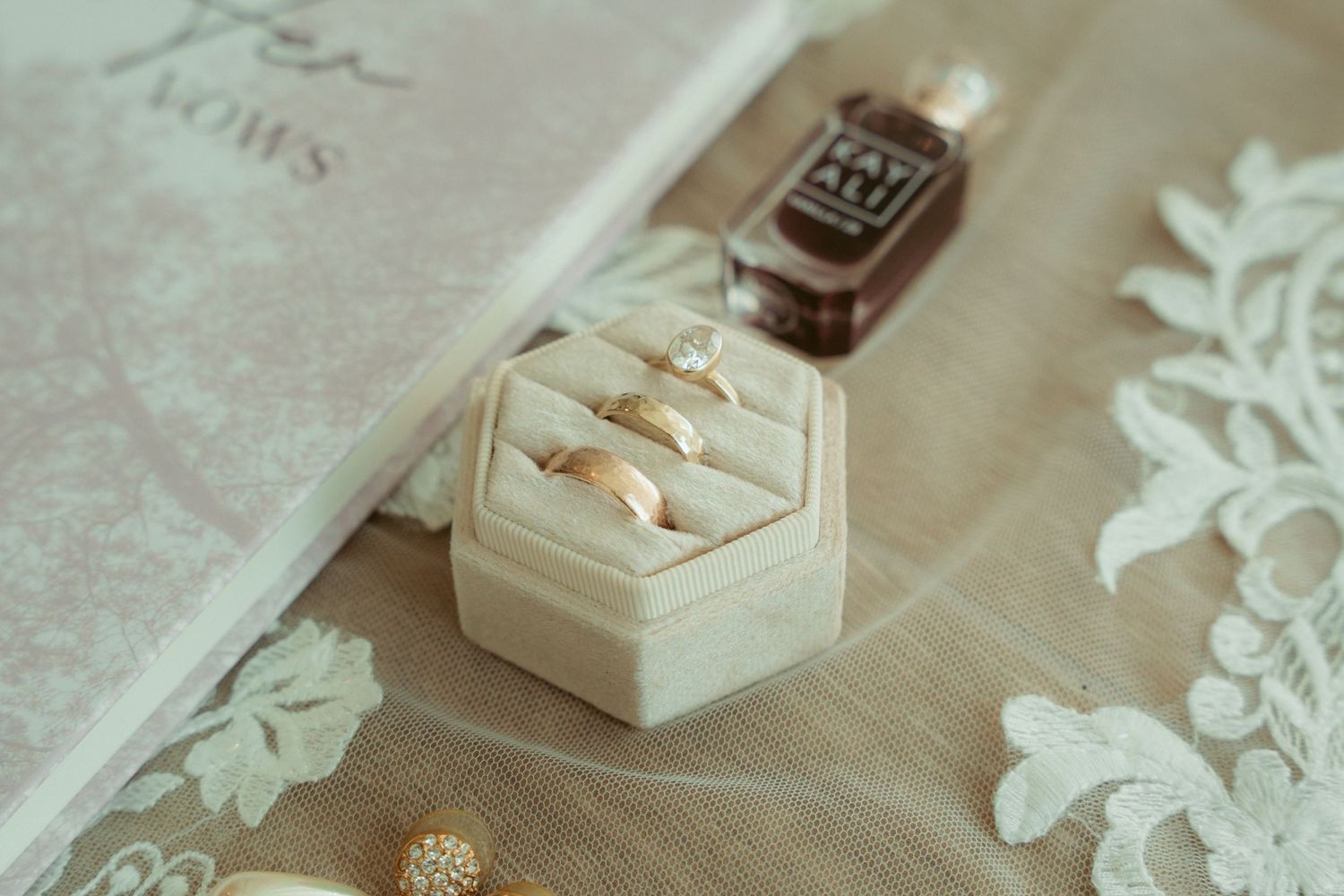 Wedding details with delicate lace and decorative elements on a light colored surface.