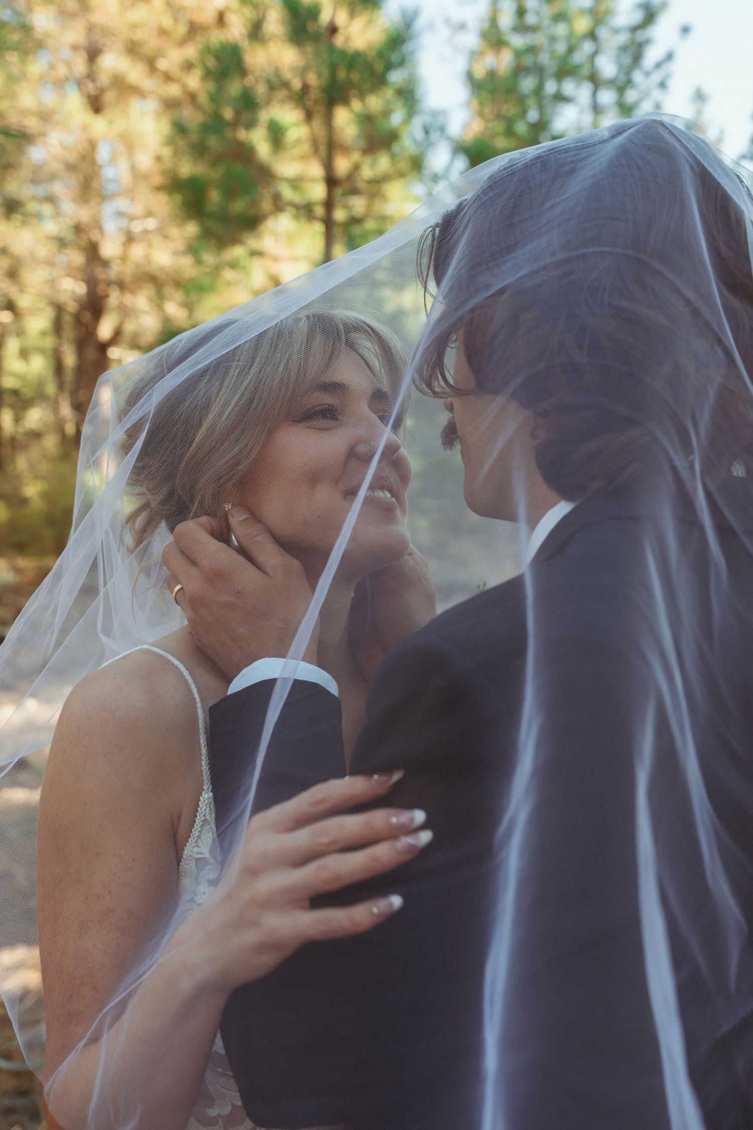 Intimate wedding portraits captured in sequence showing tender moments in a forest setting.