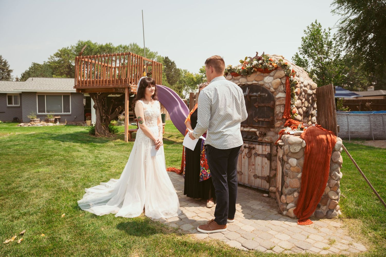 A romantic moment captured in an outdoor garden setting with rustic decor.
