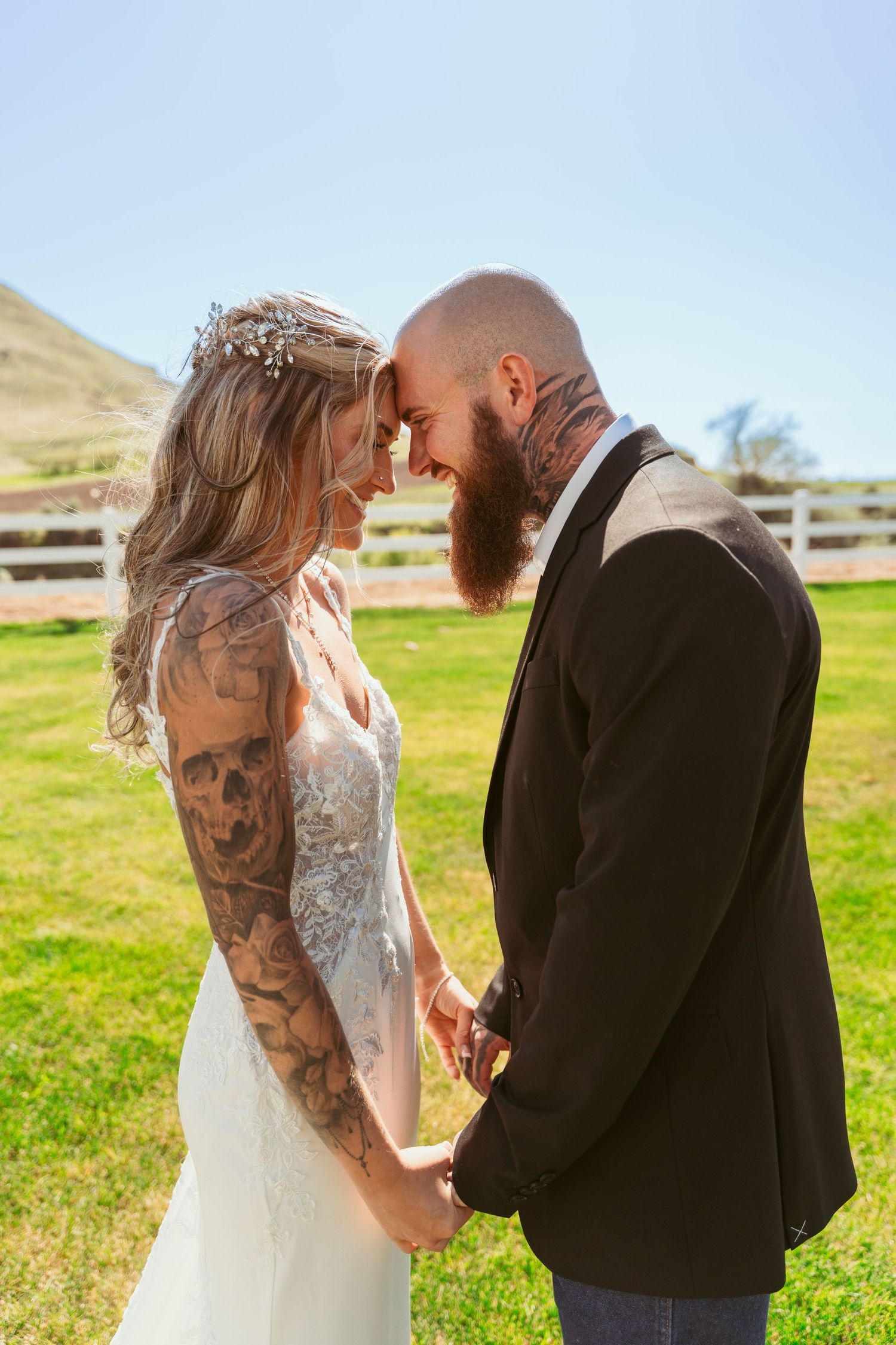 Intimate wedding moment captured in front of rustic mountain landscape.