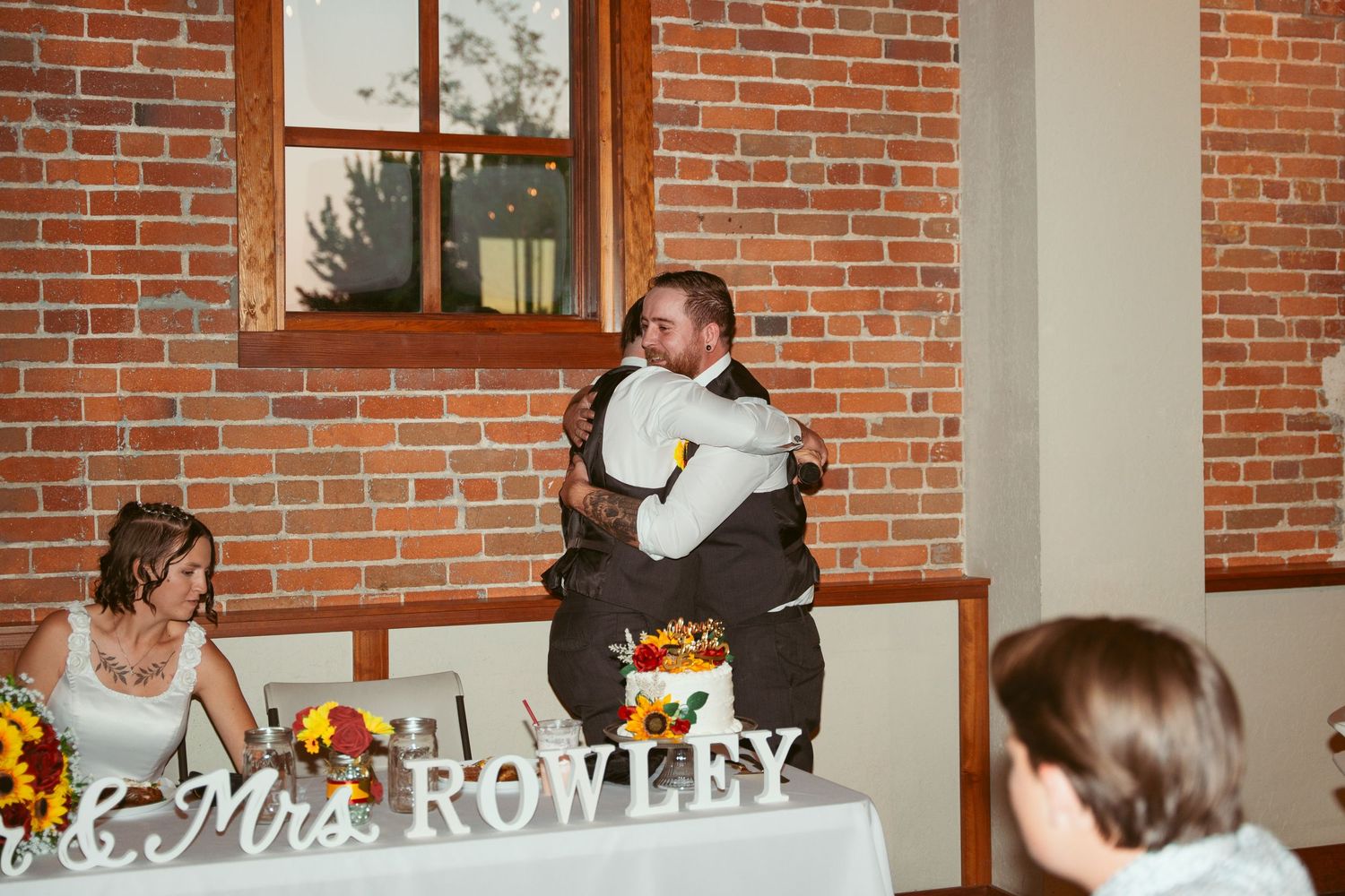 Wedding reception venue featuring brick walls and personalized name signage.