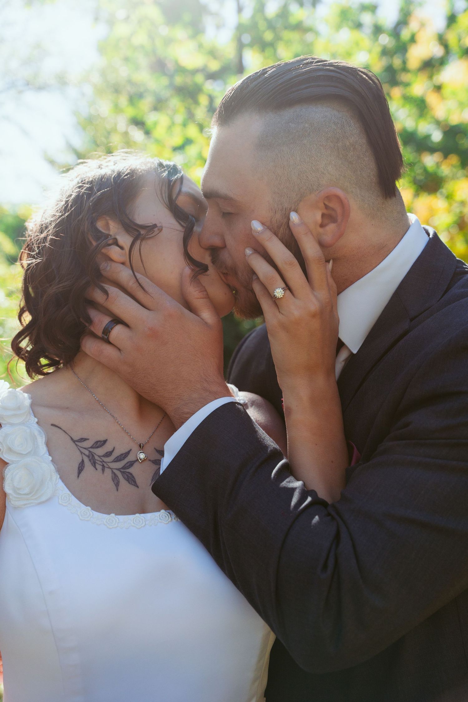 Romantic wedding kiss sequence captured in natural outdoor lighting.