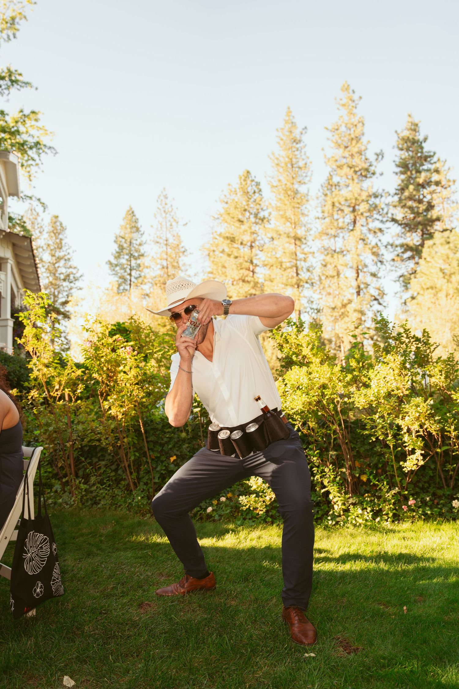 A sequence of playful dance moves performed on a grassy lawn with pine trees in the background.