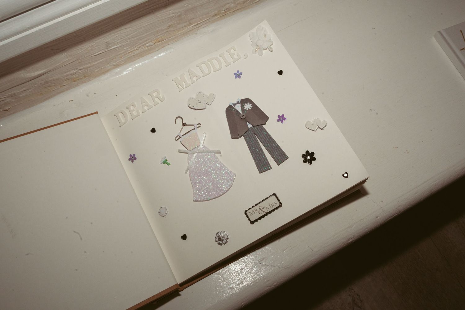 Vintage-style wedding decor illustrations showing bride and groom outfits on a cream-colored background.