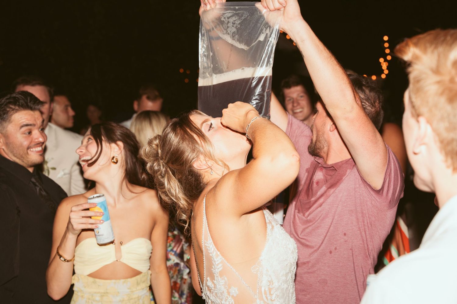 People dancing and having fun at a lively outdoor wedding reception.