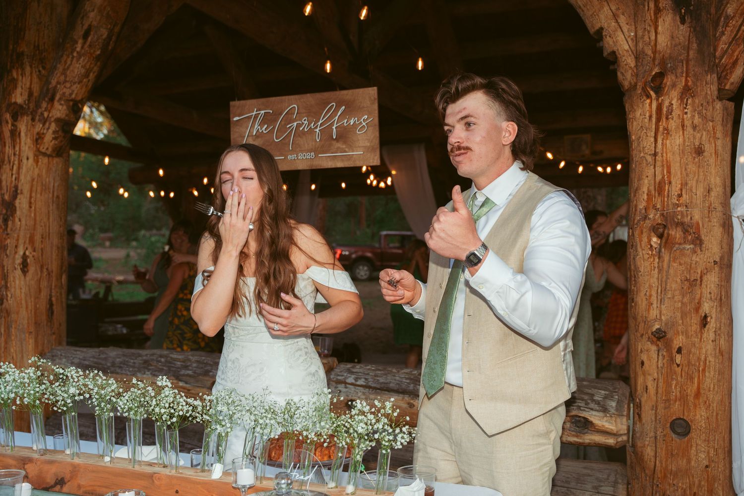 Wedding celebration in a charming barn venue with rustic wooden beams and ambient lighting.