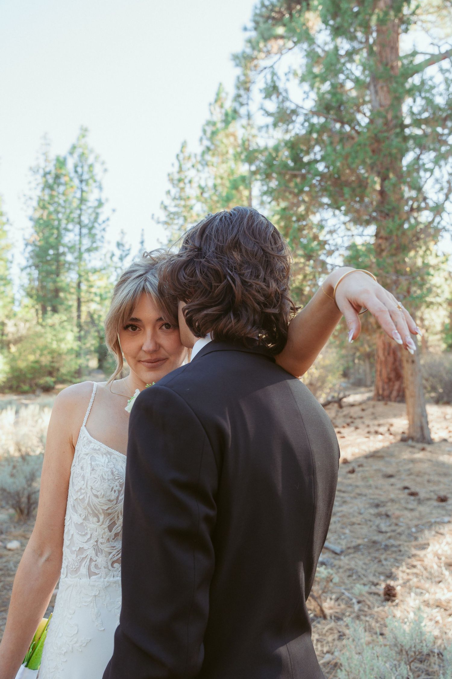 A romantic wedding photoshoot sequence in a pine forest with soft natural lighting.
