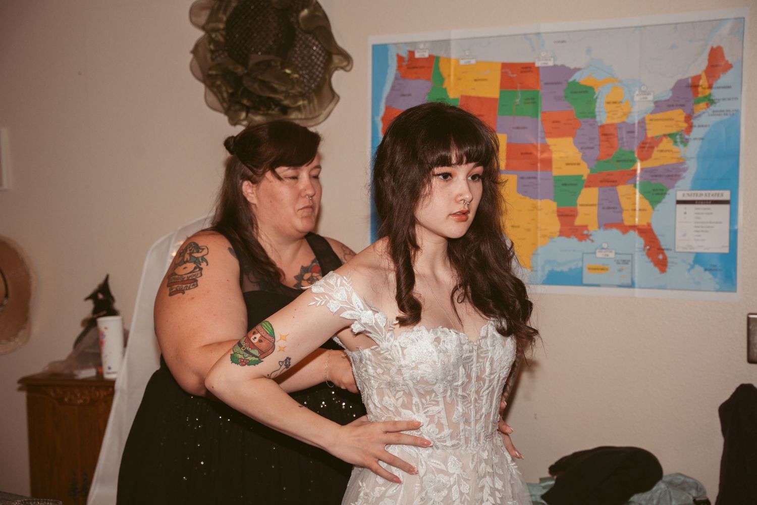 Wedding celebration scene with colorful US map displayed on wall in background.