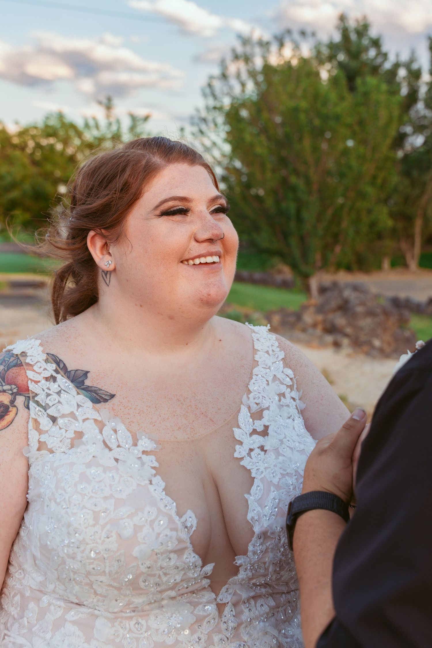 Close-up shots of a bride in a detailed lace wedding dress against a sunset sky.