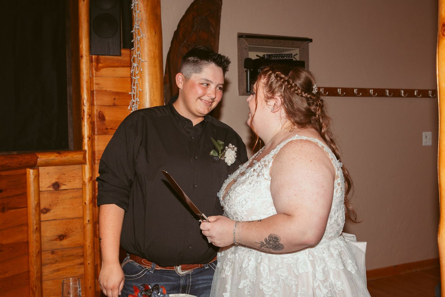 Indoor celebration at a rustic wooden venue with warm ambient lighting.
