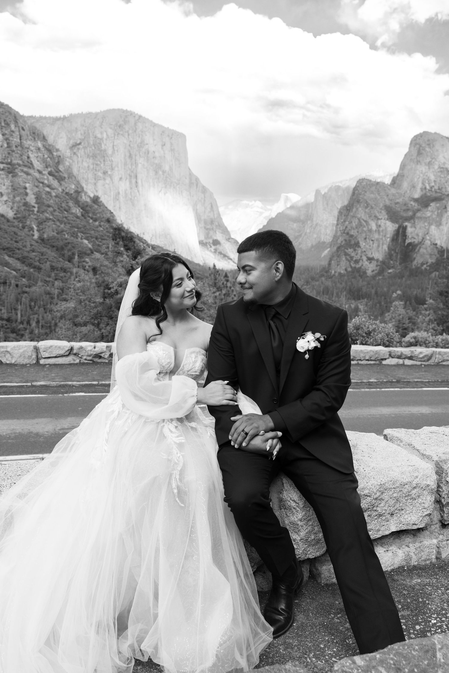 Wedding portraits captured at Tunnel View with Yosemite Valley's iconic vista in the background.