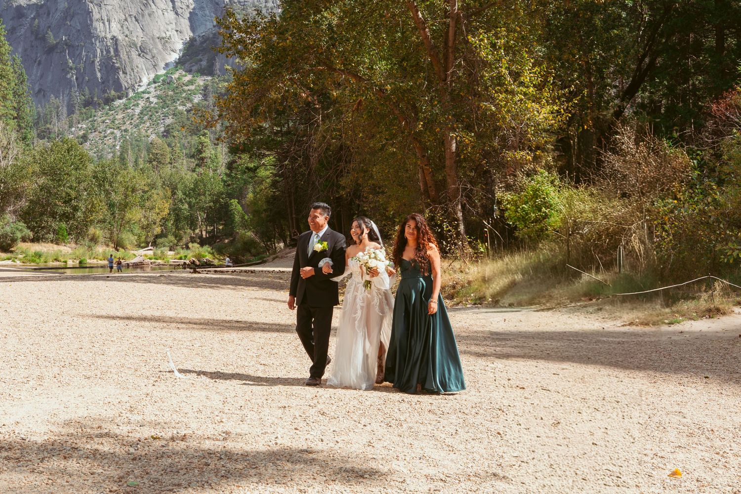 Wedding ceremony taking place in Yosemite National Park with majestic granite cliffs in the background.