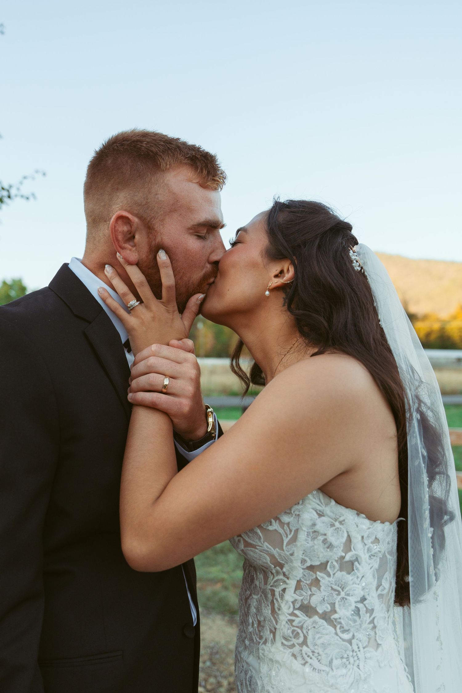 Intimate moment between newlyweds sharing their first kiss as a married couple.