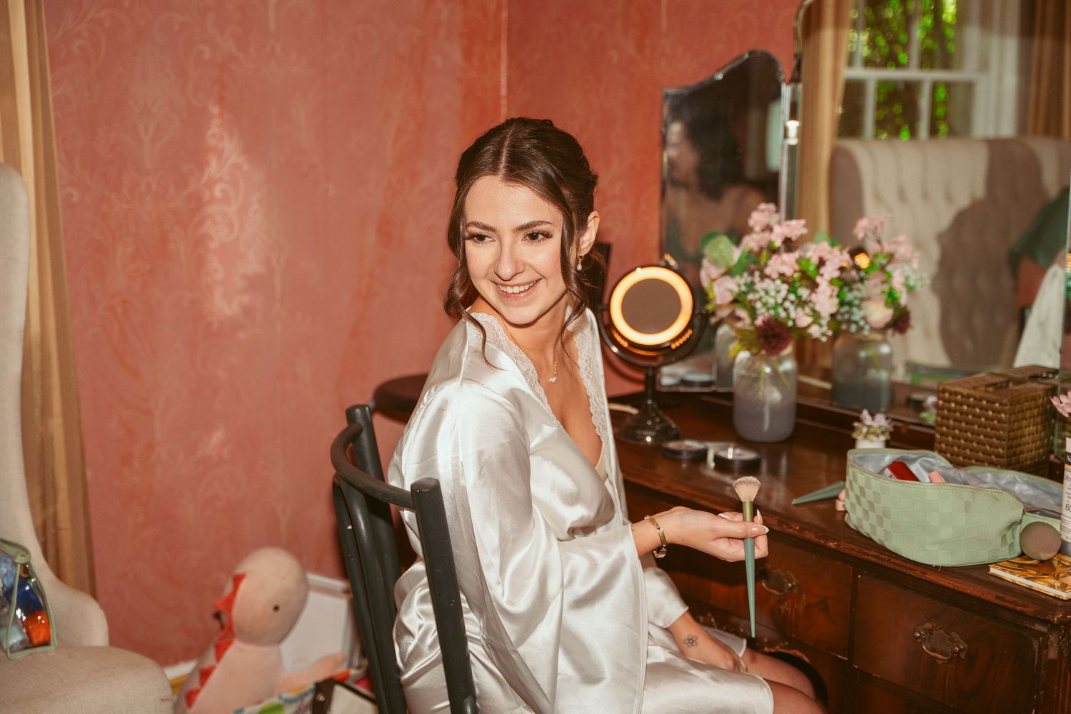Elegant dressing room scene with vintage vanity and warm lighting.