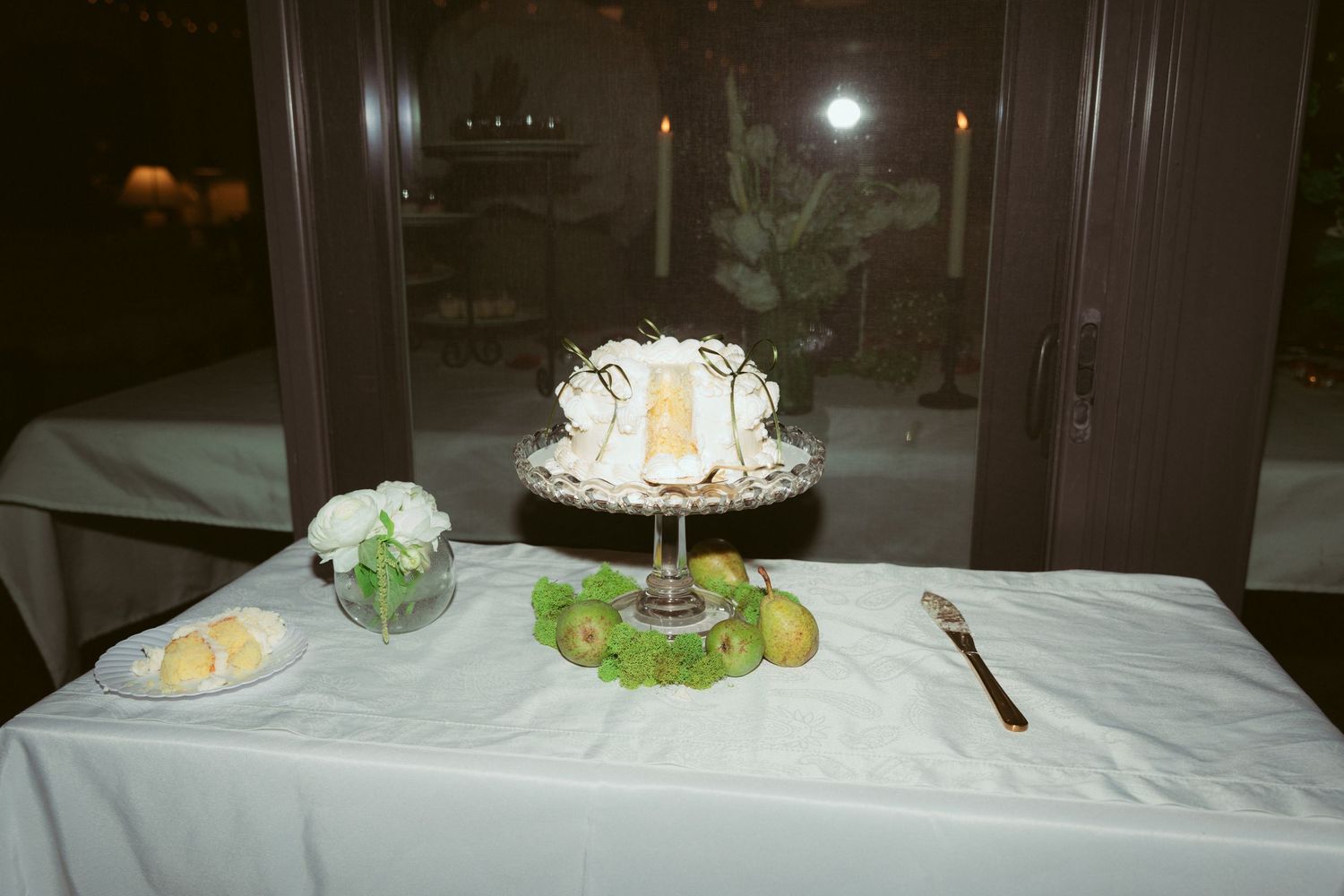 Elegant wedding reception table setup with white linens and candle centerpieces.