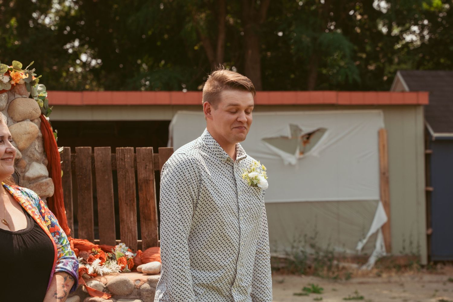 A wedding couple sharing tender moments outdoors with autumn floral arrangements and rustic decor.