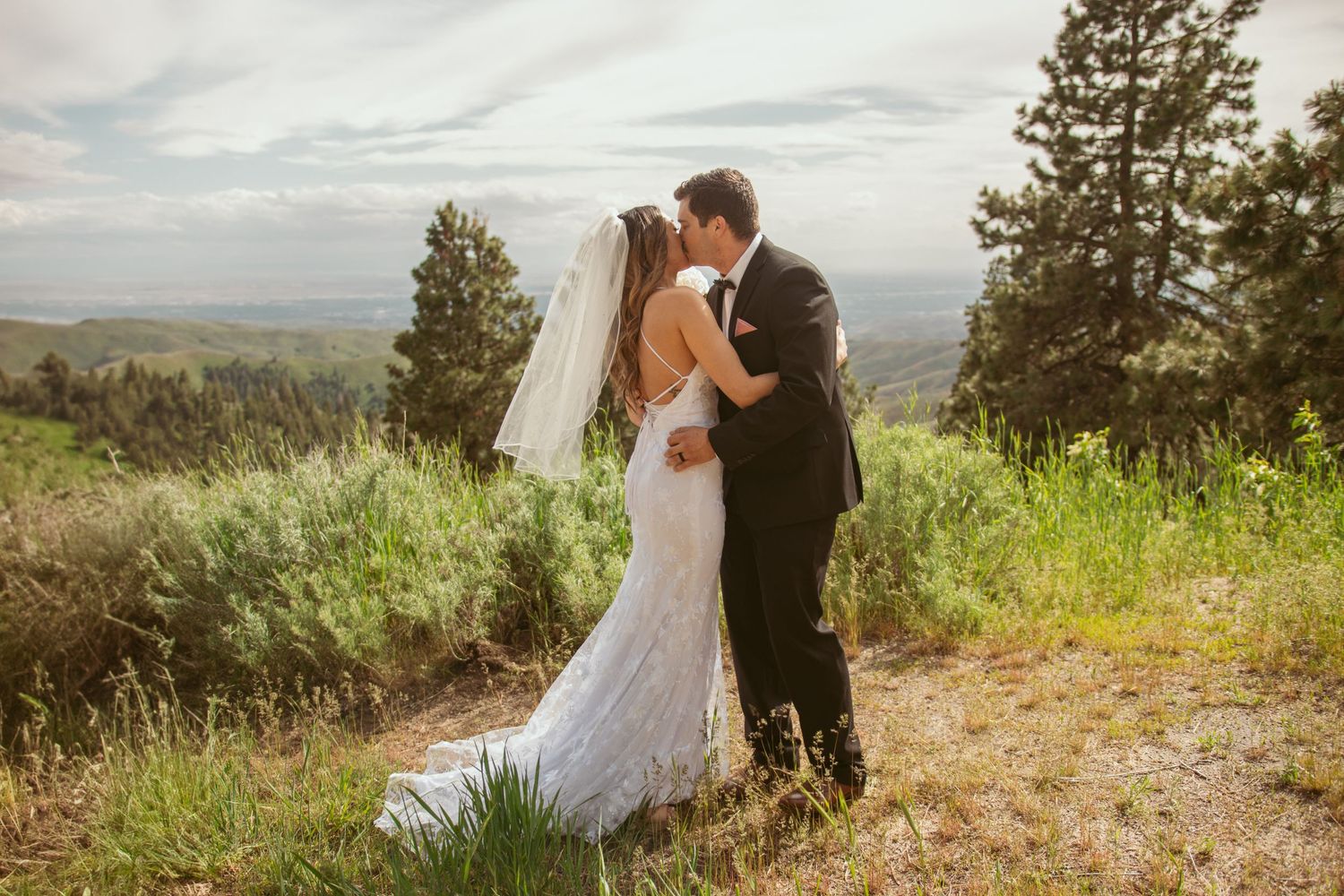 Panoramic mountain views serve as backdrop for wedding portraits.