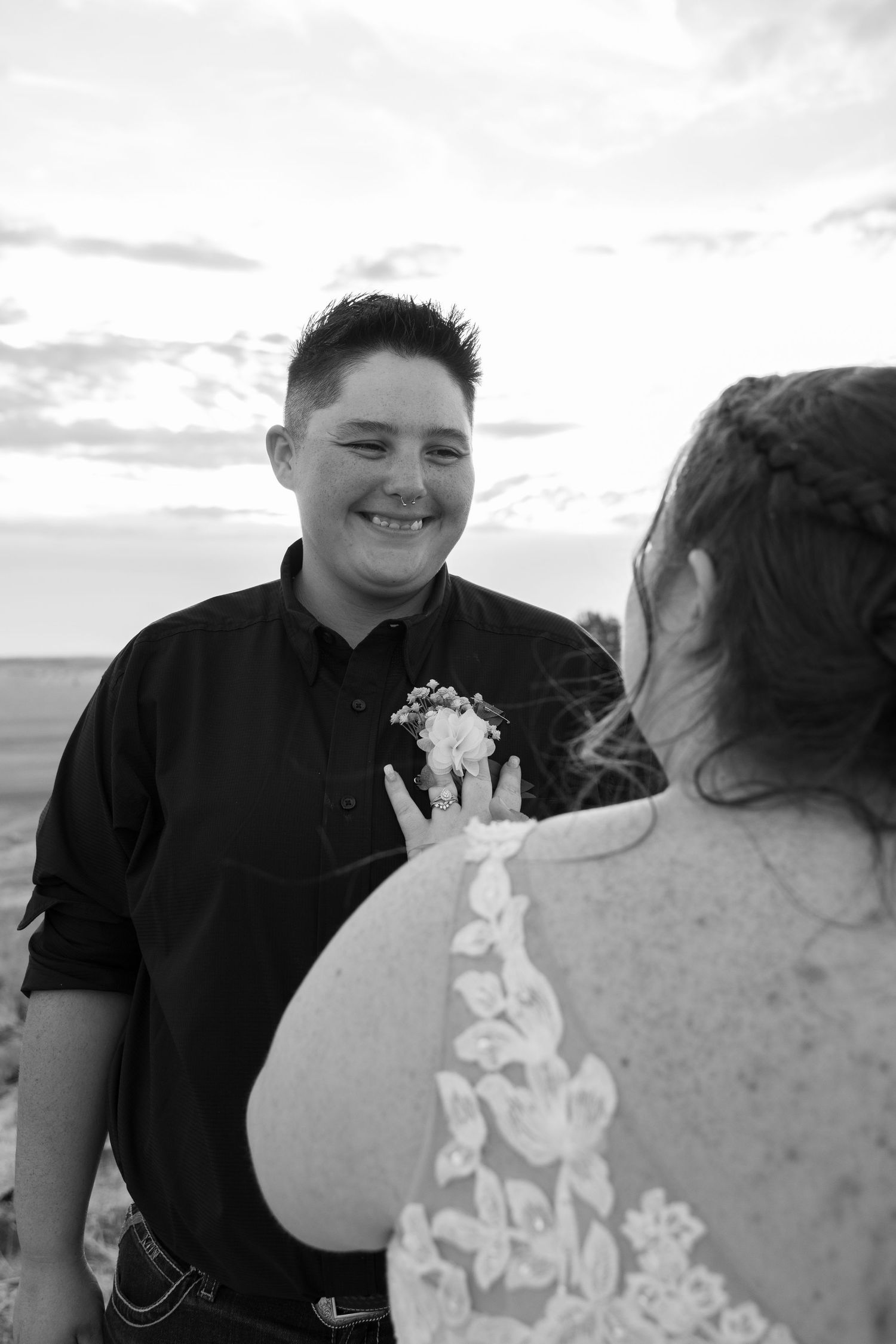 Black and white wedding portraits showing tender moments between newlyweds outdoors.