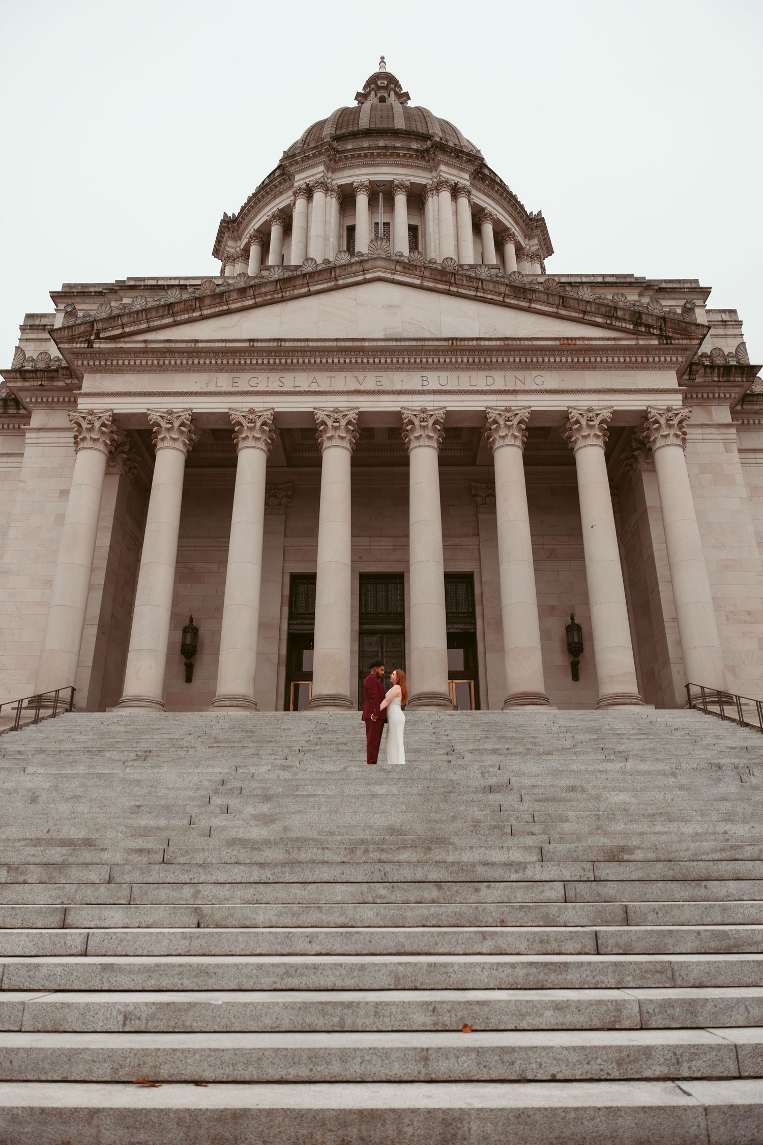 Majestic view of a neoclassical government building with grand columns and stone steps.