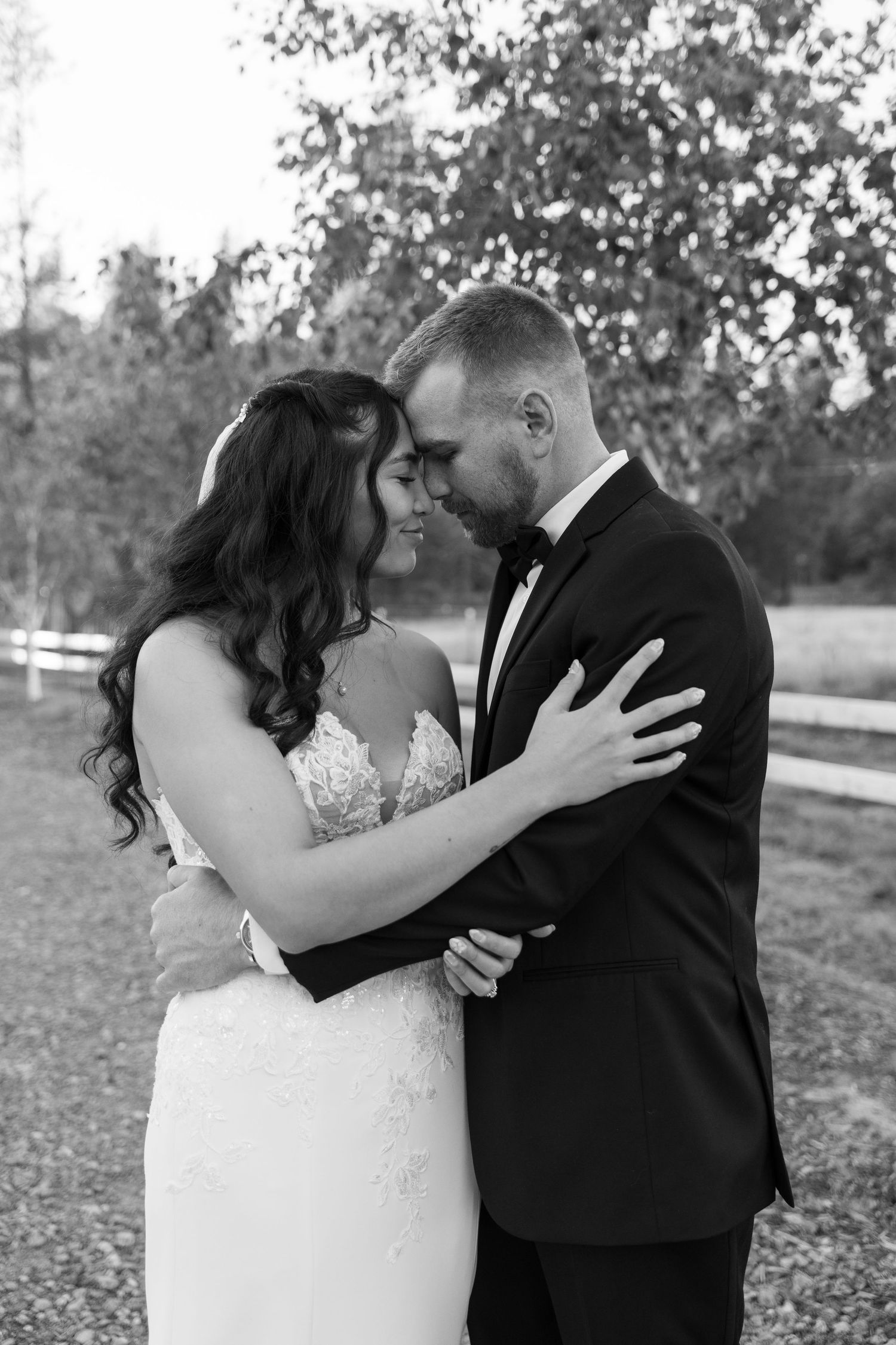 Black and white portrait captures intimate wedding moment between couple.