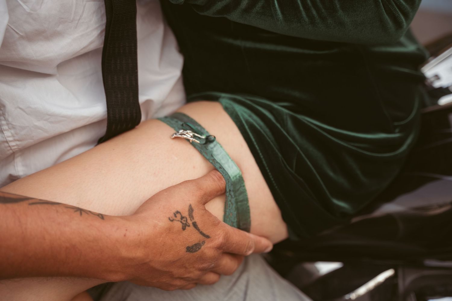Close-up shot of hands embracing in an intimate moment.