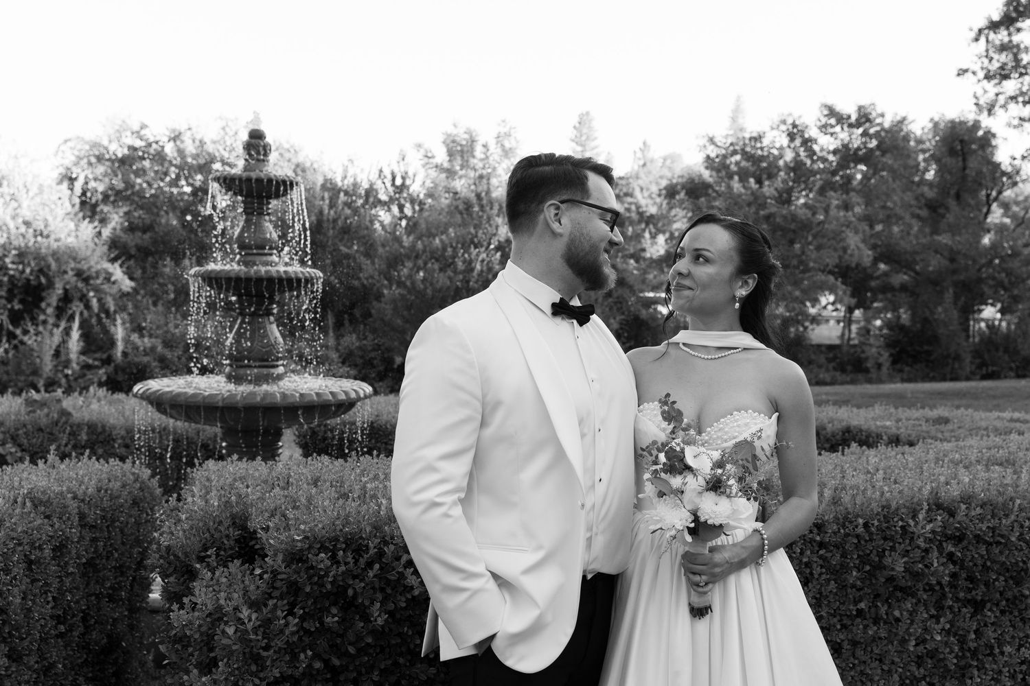 Black and white wedding portraits showing romantic moments between newlyweds.