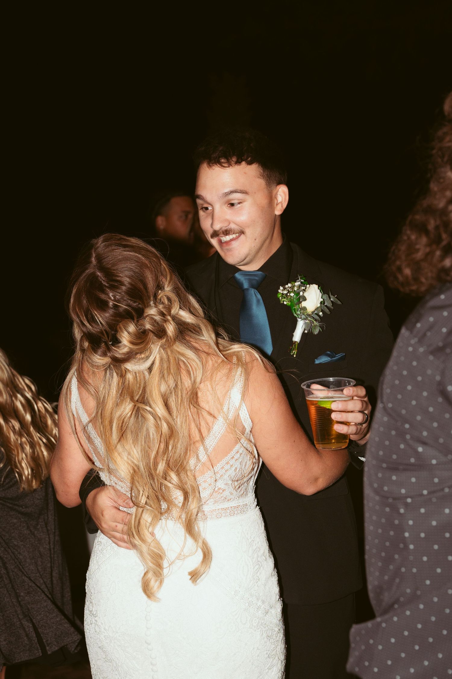 A couple shares a moment on the dance floor during their wedding reception celebration.