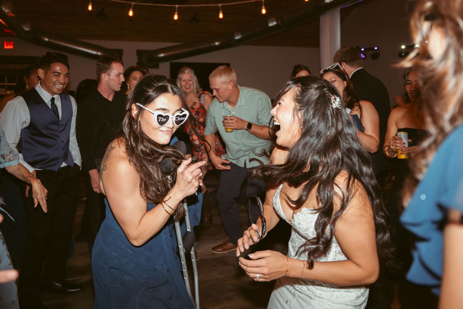Partygoers enjoying themselves on the dance floor at a formal event with ambient lighting.