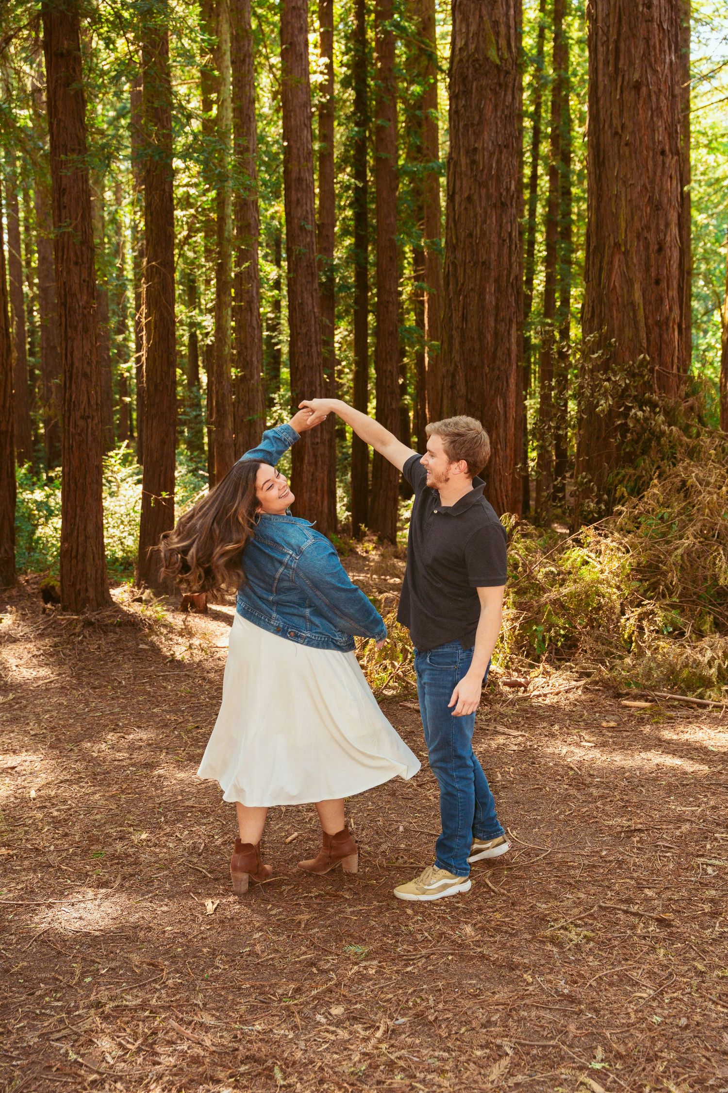 A playful dancing sequence photographed in a sunlit redwood grove.