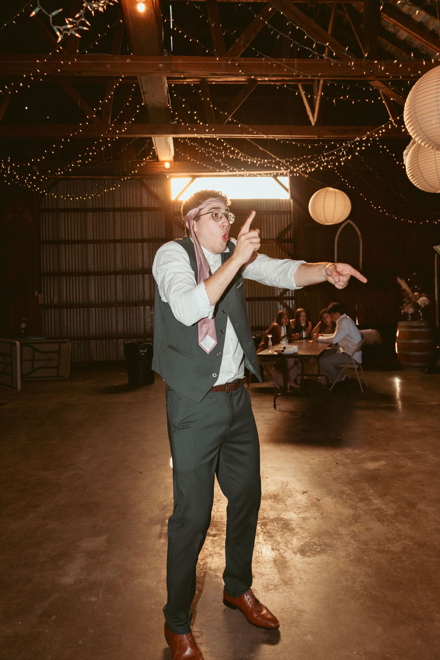Lively dance moves on display at a rustic barn wedding reception.