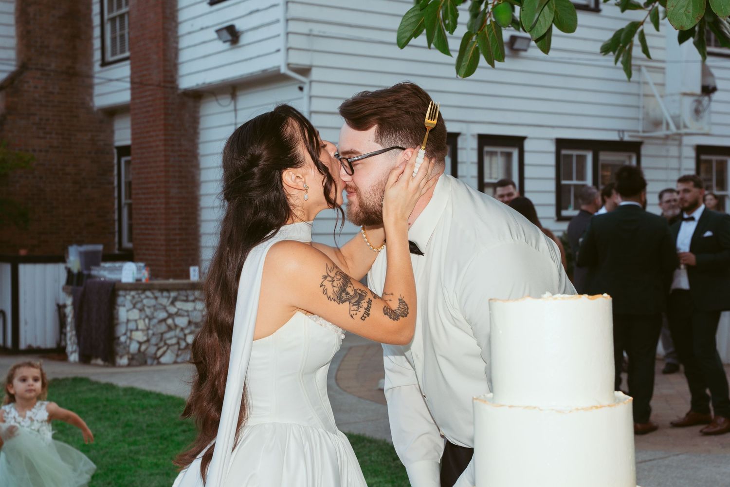A tender moment between newlyweds during their wedding cake ceremony.