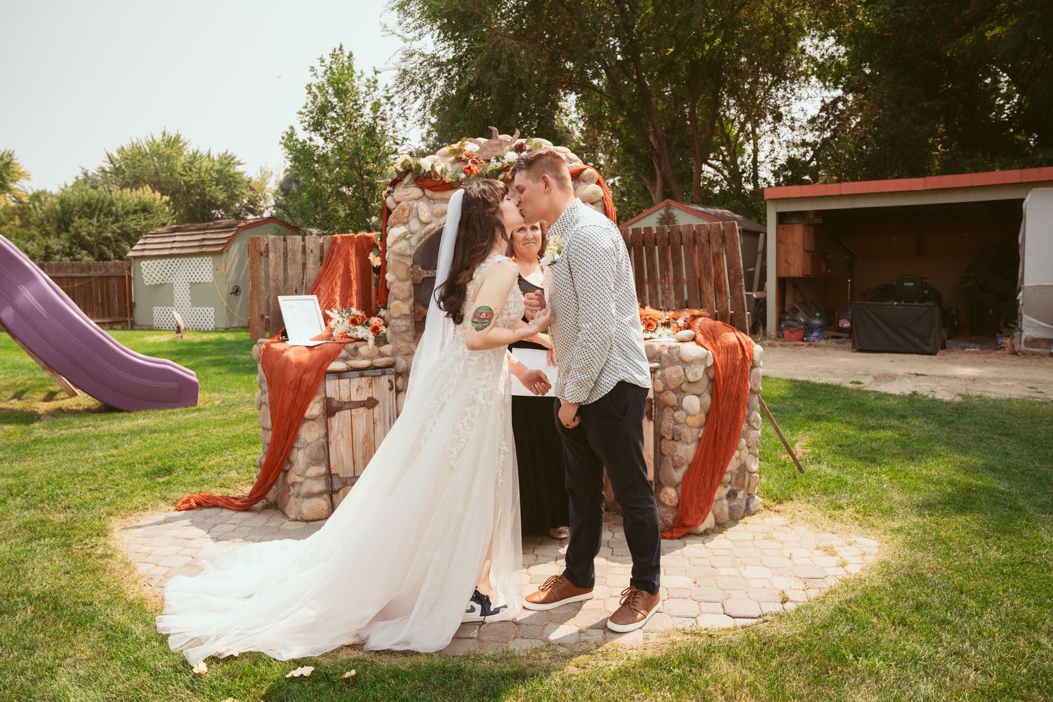 An outdoor wedding ceremony setup with rustic decor and natural lighting.