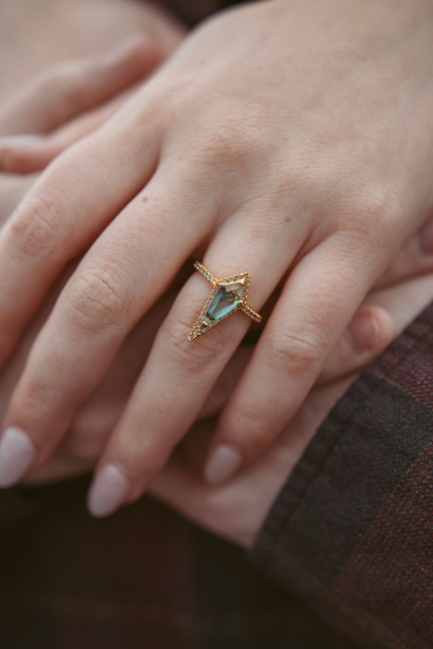 Close-up of hand wearing delicate turquoise ring.