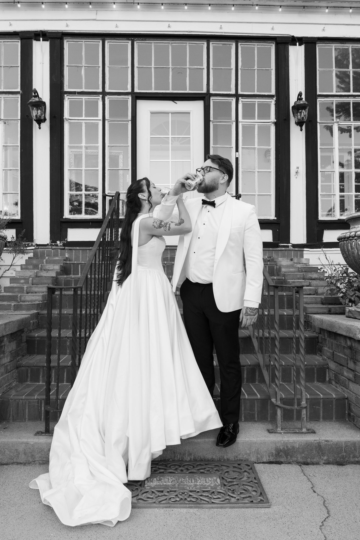 A series of black and white wedding photos showing a couple in formal attire outside a brick building with large windows.