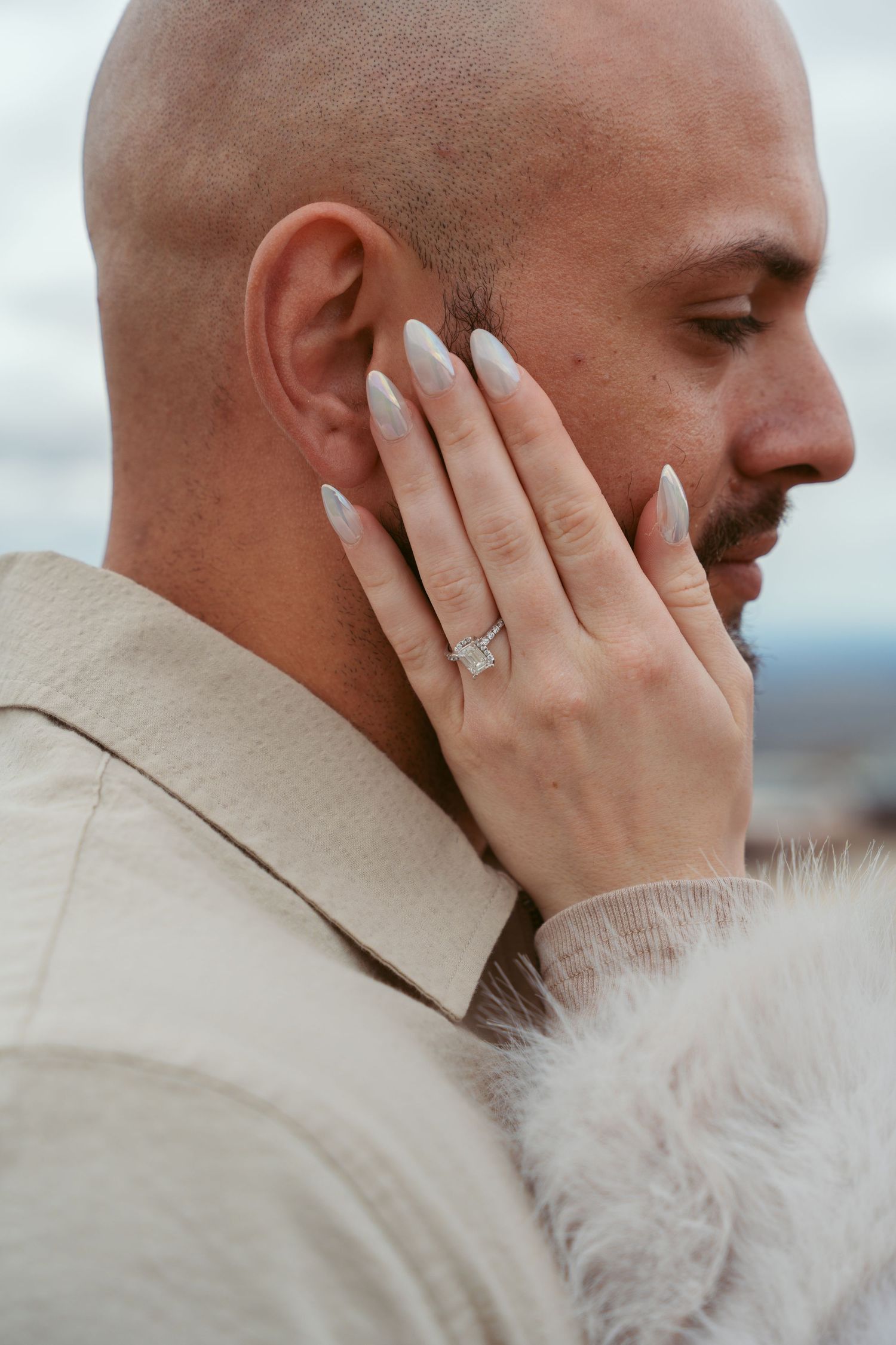 Close-up profile shots showing tender moments between a couple in neutral tones.