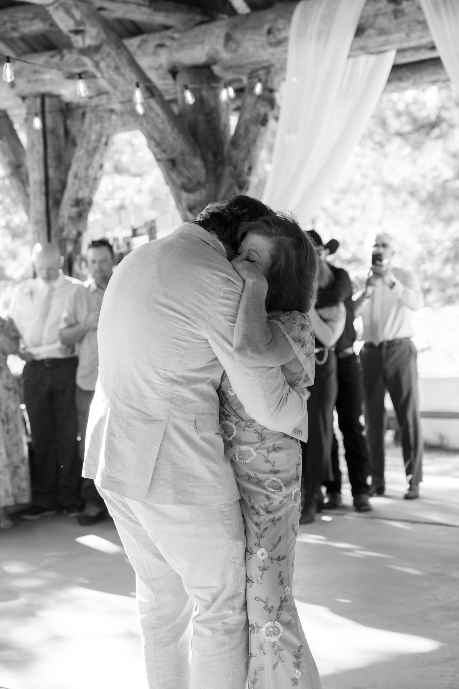 Black and white photos show a couple dancing closely together at an outdoor covered venue.