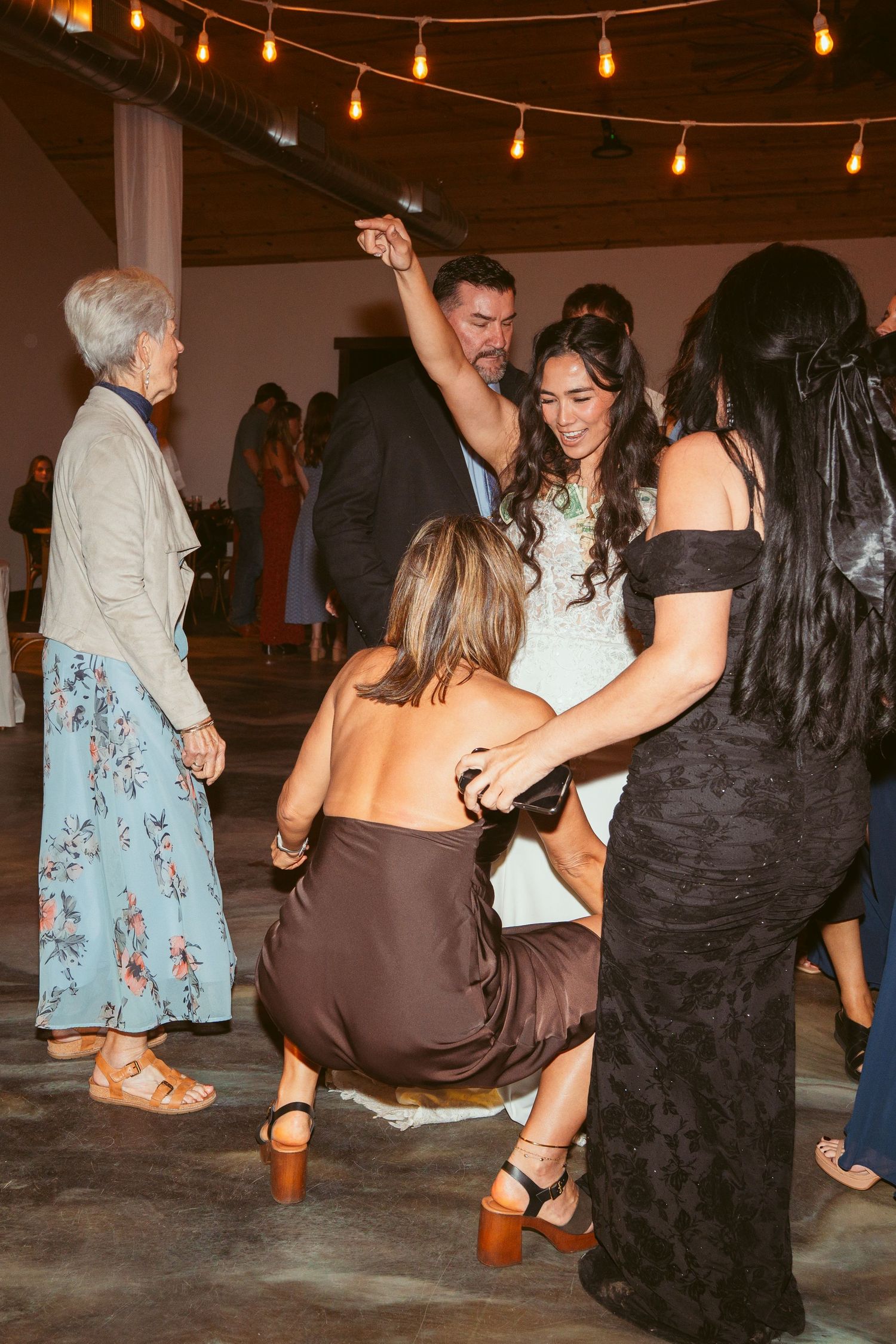 Energetic dance moves on display during wedding reception party.