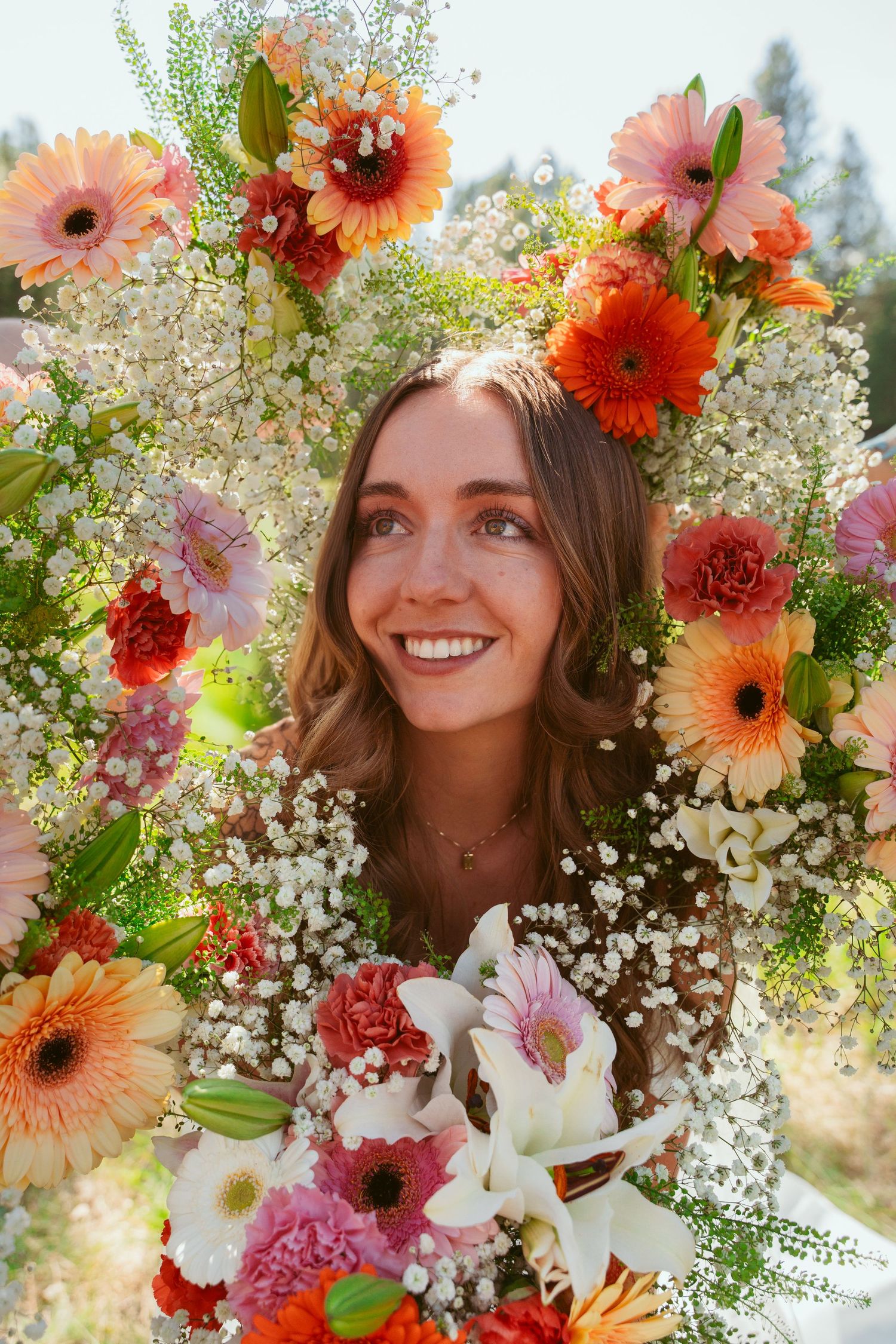 Floral crown with orange gerbera daisies and baby's breath creates whimsical bridal look.
